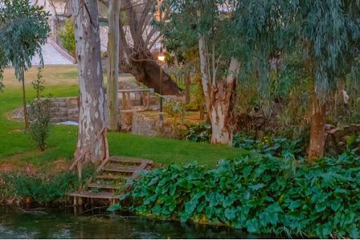 Lawn and landscape that meets the edge of a river